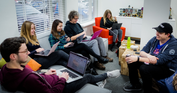 A few people of team Yoast sitting and working together